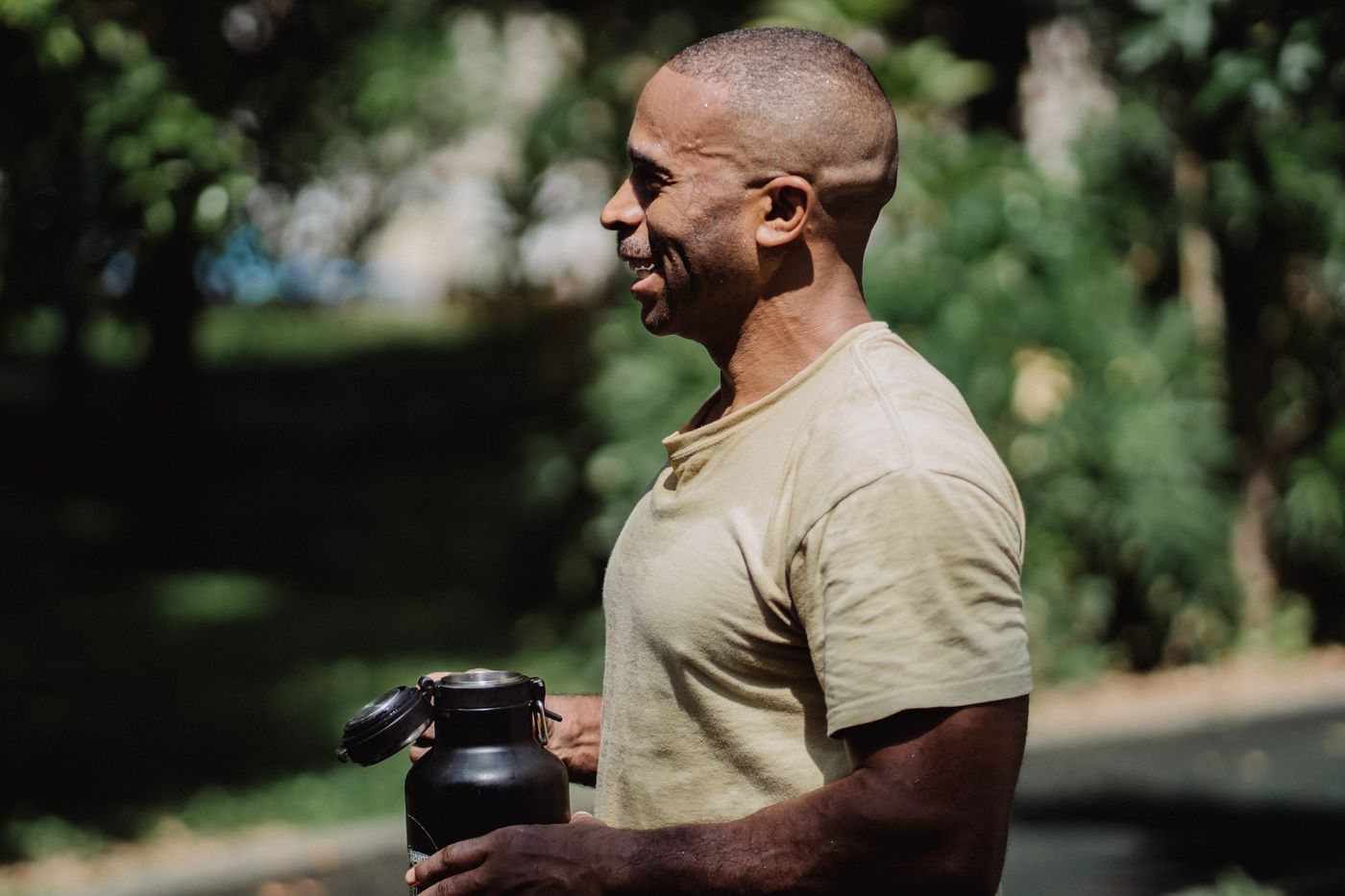 A walker holding a reusable drinks bottle outdoors
