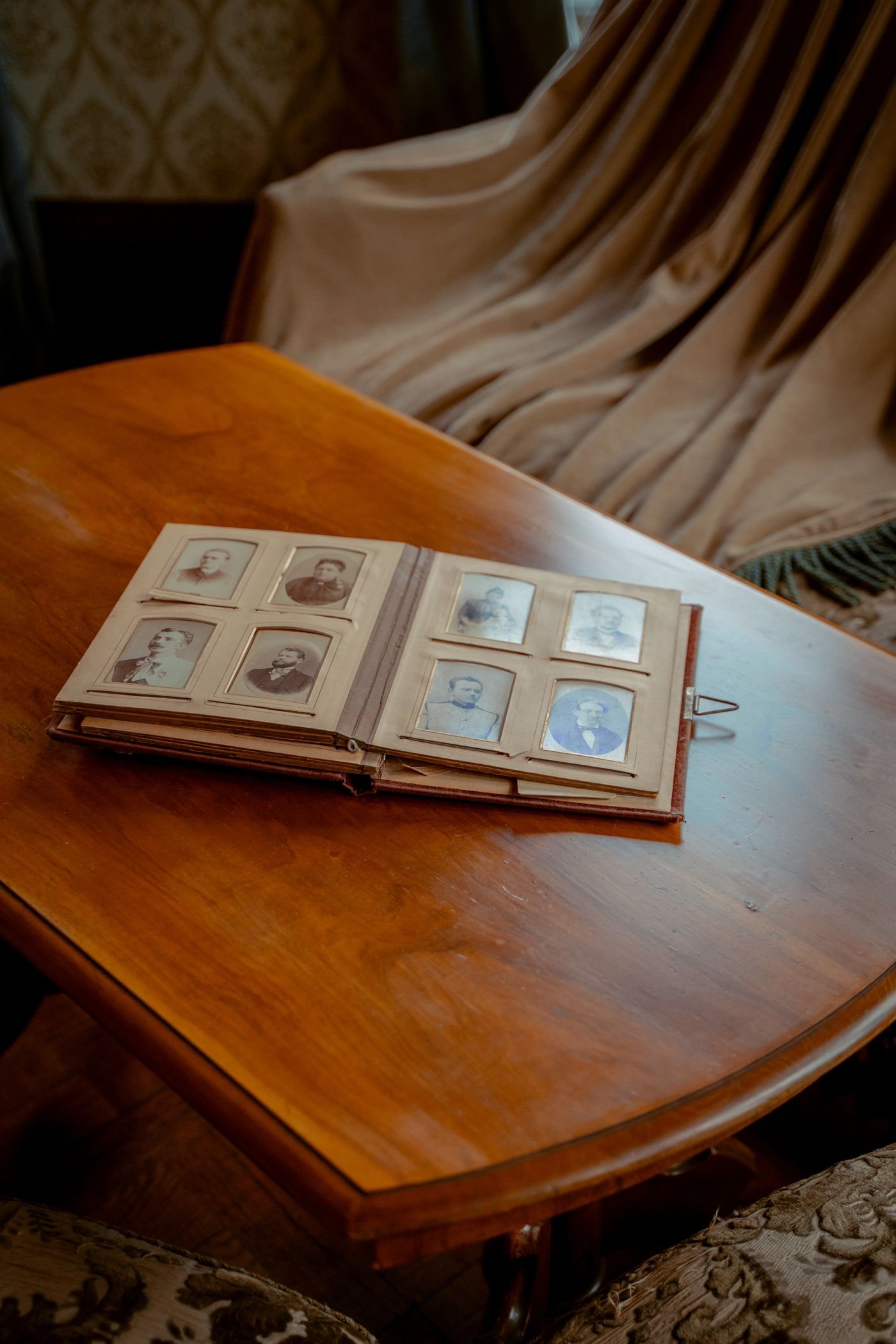 A vintage photo album open on a wooden table