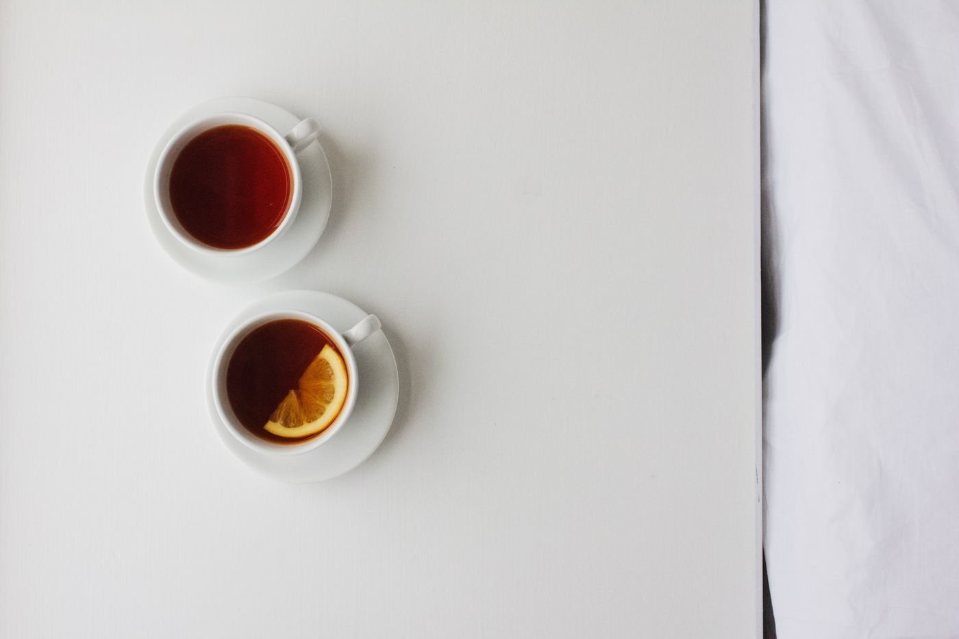 Two cups of tea arranged together on a table