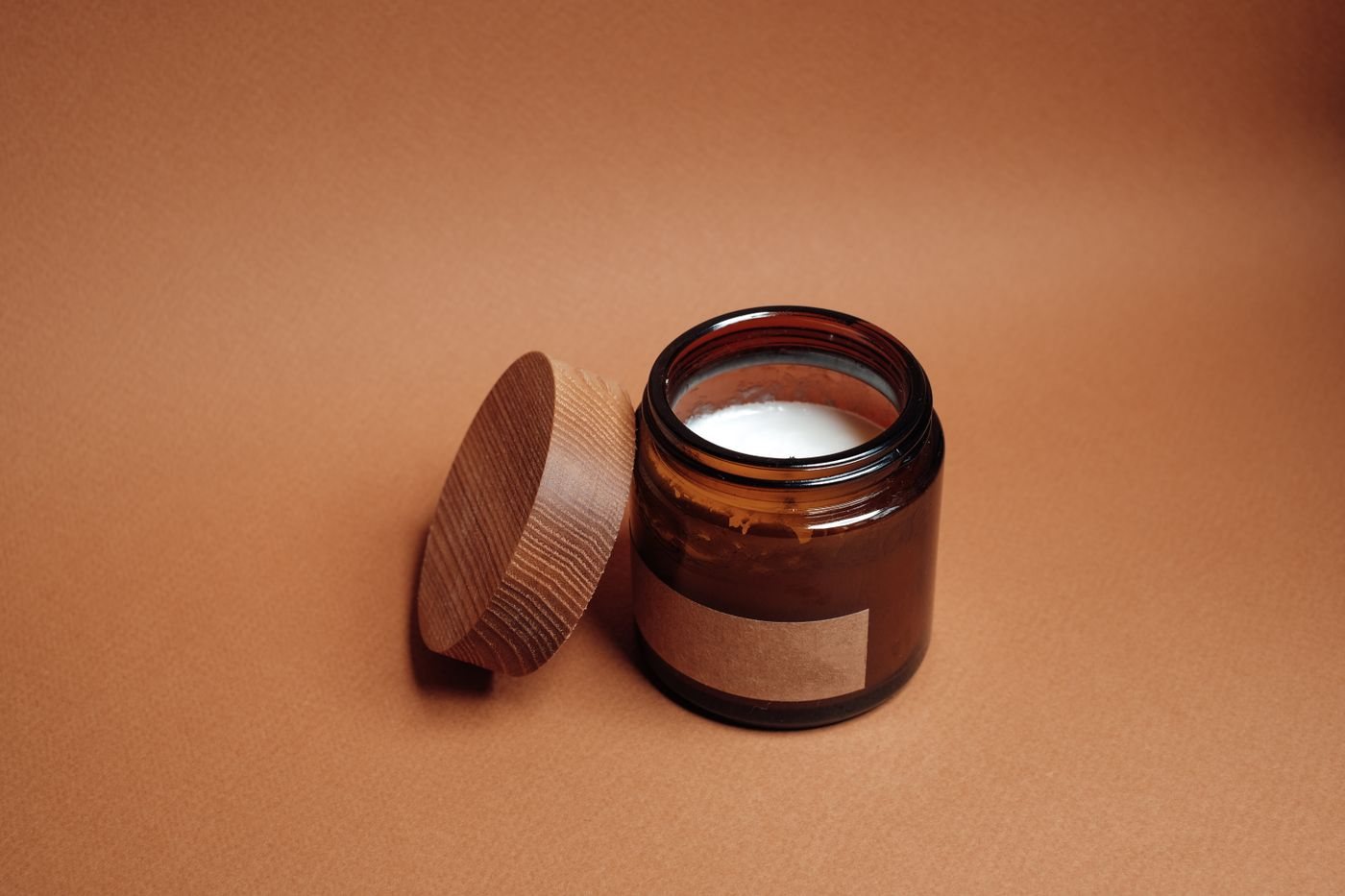 A candle in an amber glass jar