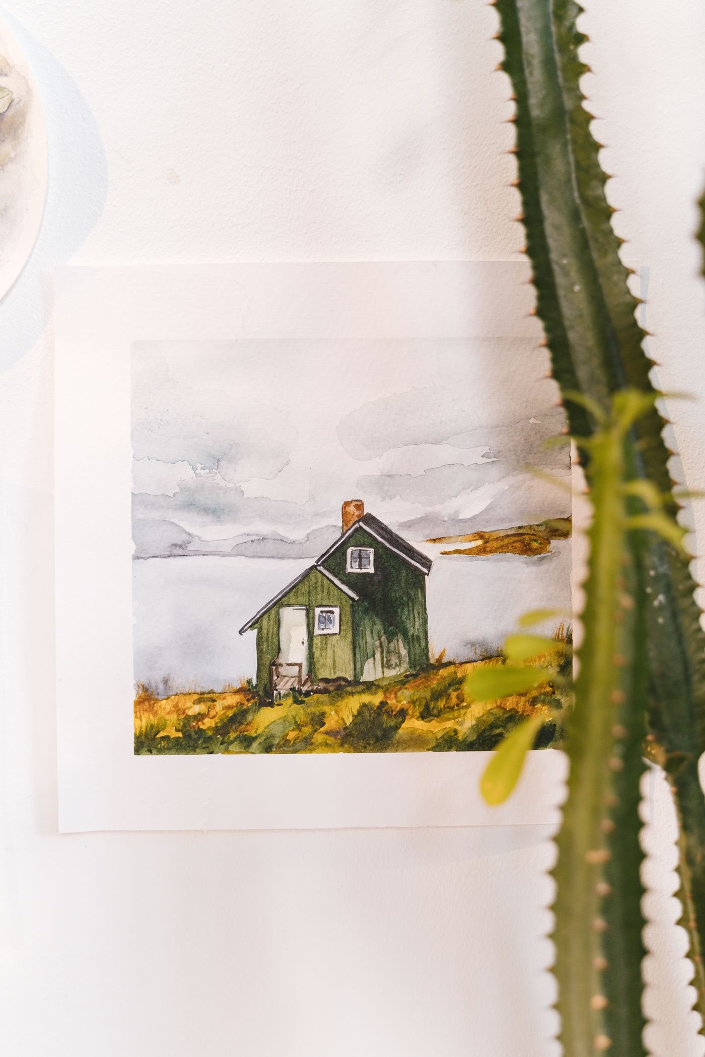 A colourful house illustration displayed on a wall