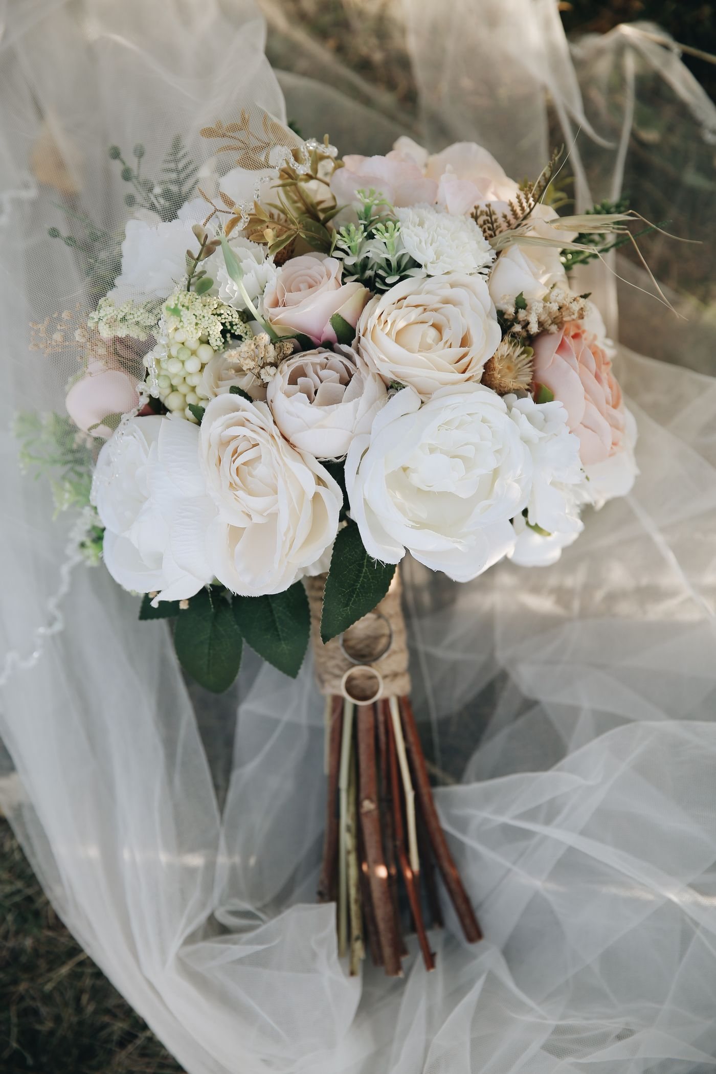 A bridal bouquet of pale flowers tied together