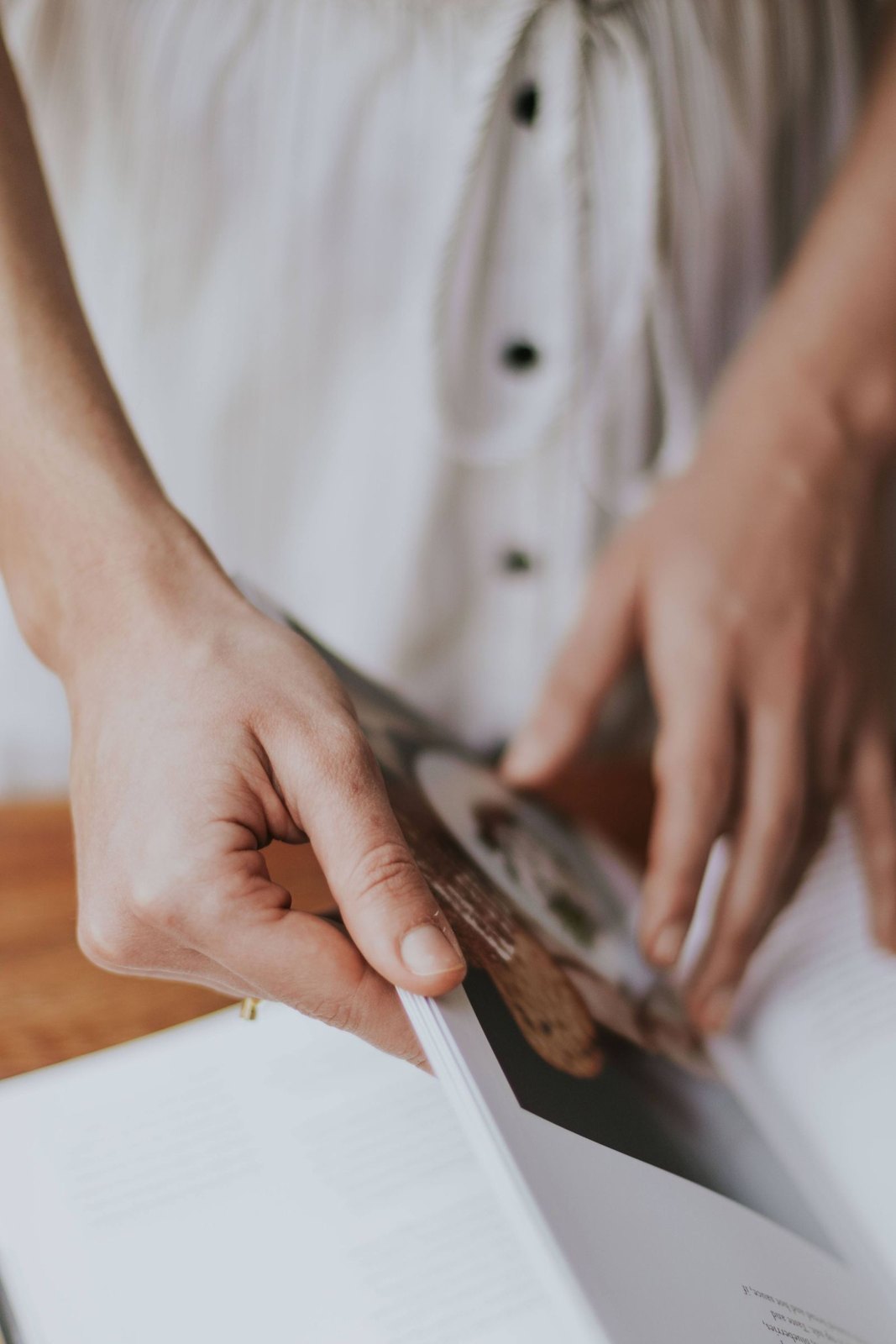 Hands looking through the pages of a recipe book