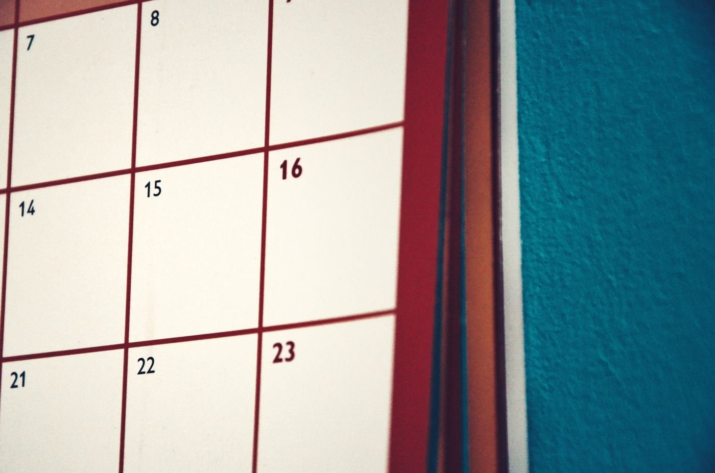 Paper calendar hanging on a colourful wall
