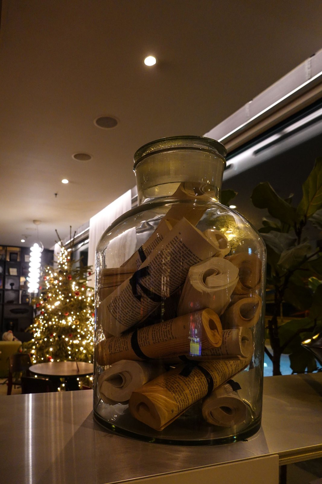 Rolled paper notes collected in a clear glass jar