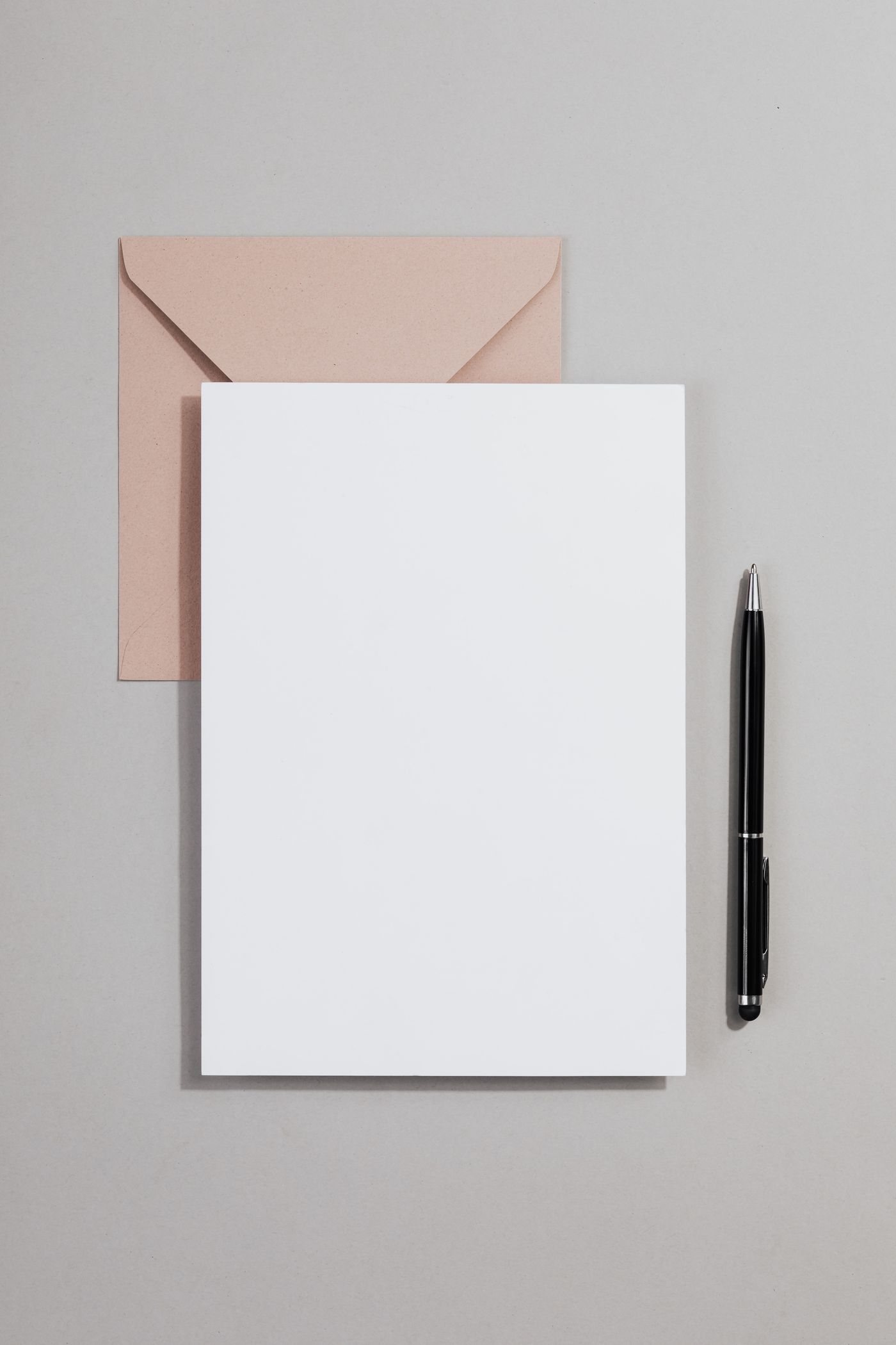 A pen, blank sheet of paper and envelope